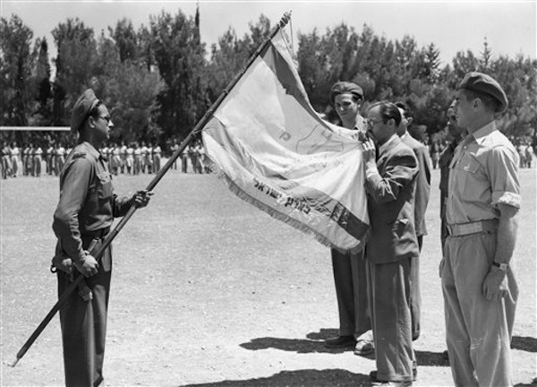 Menachem Begin, the Irgun coast flag on August 4, 1948, when the terrorists were incorporated into the Israeli army.