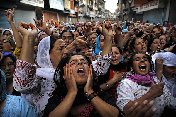 2009 Srinagar, India. Relatives and neighbors of Yasir Rafiq, a relative of a senior separatist leader Yasin Malik, mourn at his funeral. Rafiq was injured when he was shot while play a board game in the street after curfew.