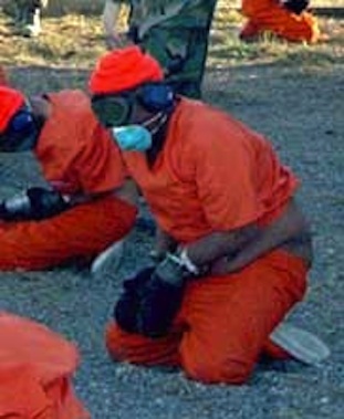 Camp X-Ray prisoners. They wear sensory deprivation masks. [Source: US Navy]