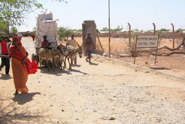 People cross from Somalia into Kenya at the Mandera border control post. Kenya's borders have hundreds of unofficial entry points that police are working to close.
