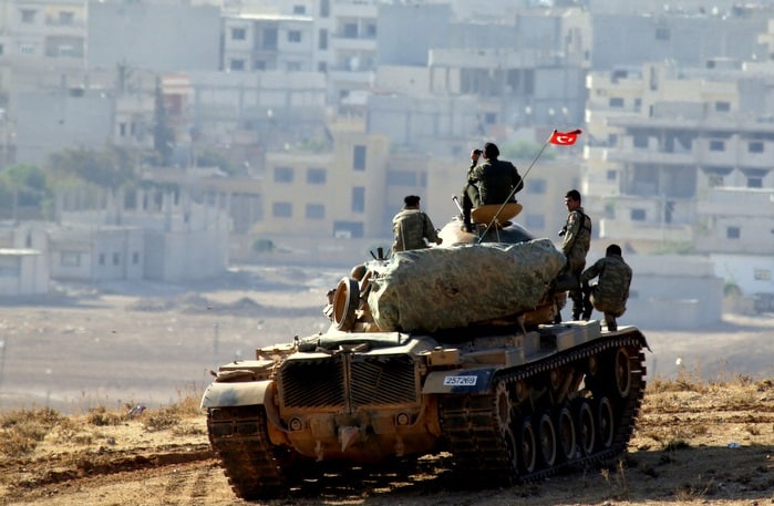 Turkish-Army-tank-looking-at-Kurdish-village